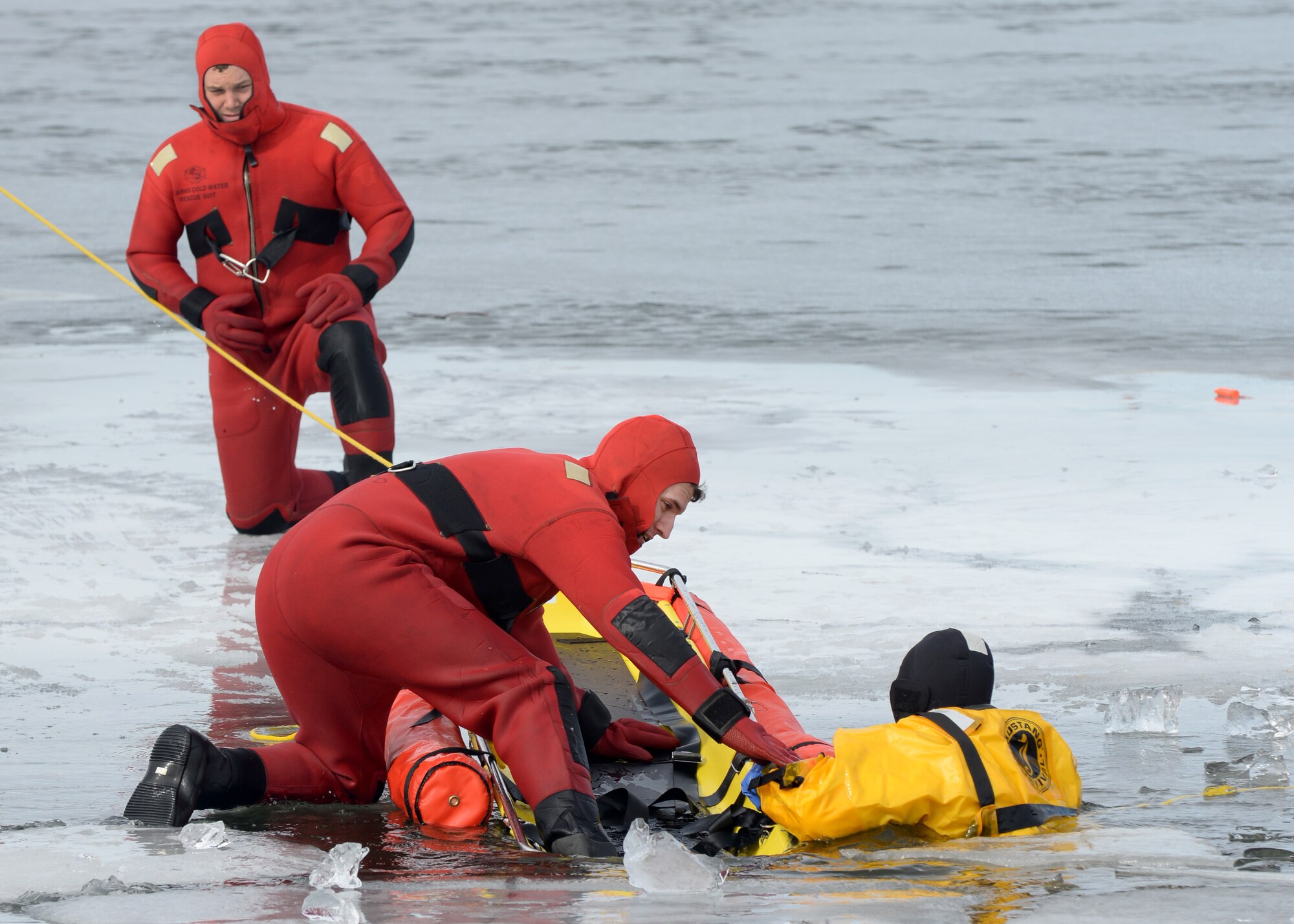 Airmen from the 28th Civil Engineer Squadron Fire Department practice rescue techniques with a stokes basket during ice rescue training at Ellsworth Air Force Base, S.D., Feb. 17, 2016. While in cold regions, ice rescue techniques play a vital role in winter safety. (U.S. Air Force photo by Senior Airman Rebecca Imwalle/Released)