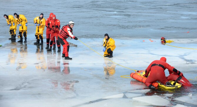Airmen from the 28th Civil Engineer Squadron Fire Department participate in ice rescue training at Ellsworth Air Force Base, S.D., Feb. 17, 2016. Airmen practiced rescuing victims using an individual rope, a backboard, stokes basket, inflatable boat and a supportable water bridge. (U.S. Air Force photo by Senior Airman Rebecca Imwalle/Released)  