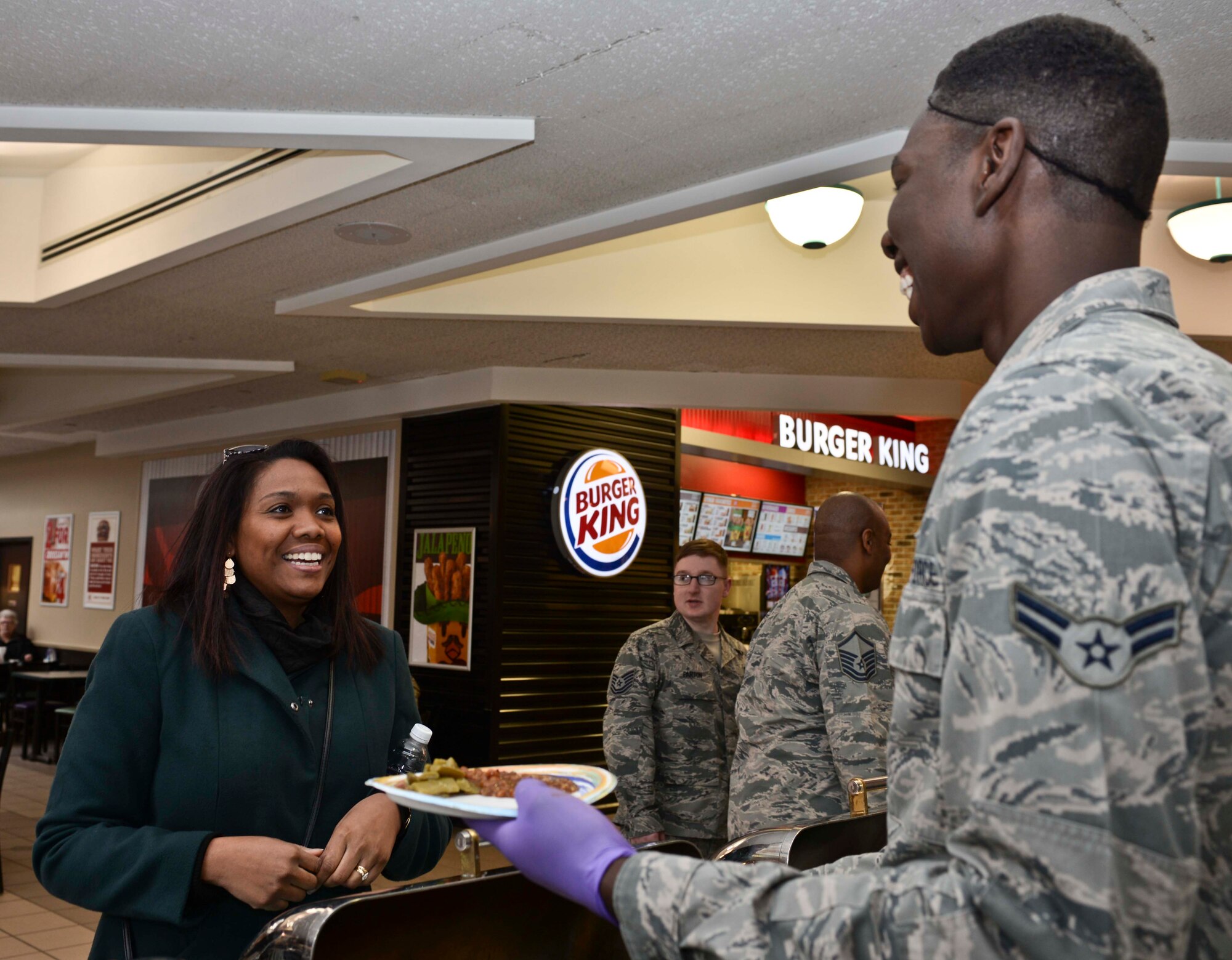 Bernie McFarling, 28th Bomb Wing Staff sexual assault response coordinator, receives a helping of African American cuisine during the Black History Month luncheon at Ellsworth Air Force Base, S.D., Feb. 24, 2016. In 1976, President Gerald R. Ford recognized the observance as an official holiday, and since then the month of February has been designated as Black History Month. (U.S. Air Force photo by Airman Sadie Colbert/Released)