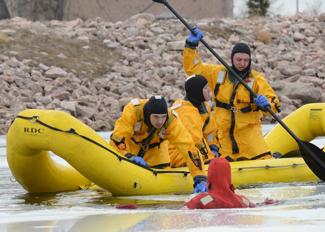 Airmen from the 28th Civil Engineer Squadron Fire Department utilize an inflatable rescue boat during ice rescue training at Ellsworth Air Force Base, S.D., Feb. 17, 2016. The two-day ice rescue training provided Ellsworth Airmen a chance to gain knowledge on important life saving techniques. (U.S. Air Force photo by Senior Airman Rebecca Imwalle/Released)