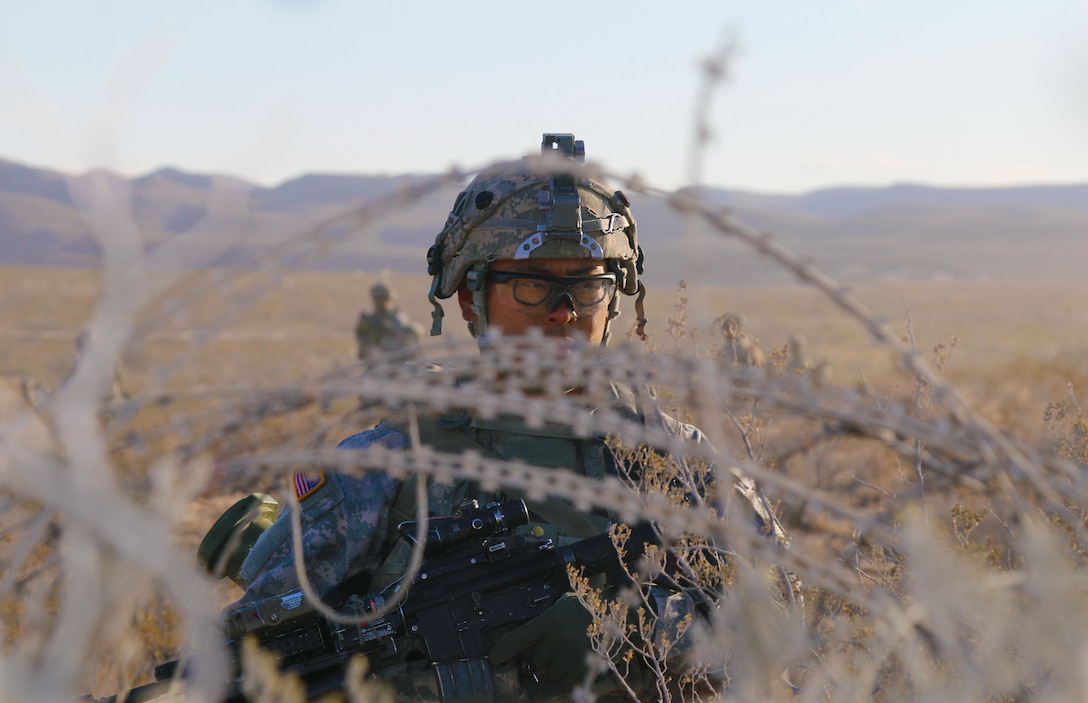 Pfc. Joel Moon, an infantryman with B Company, 3rd Battalion, 7th Infantry Regiment, 2nd Infantry Brigade Combat Team, 3rd Infantry Division, provides rear security while other Soldiers maneuver forward during his company live-fire exercise at McGregor Range, N.M., Jan. 26, 2016. (U.S. Army Photo by Spc. Von Marie Donato/Released)