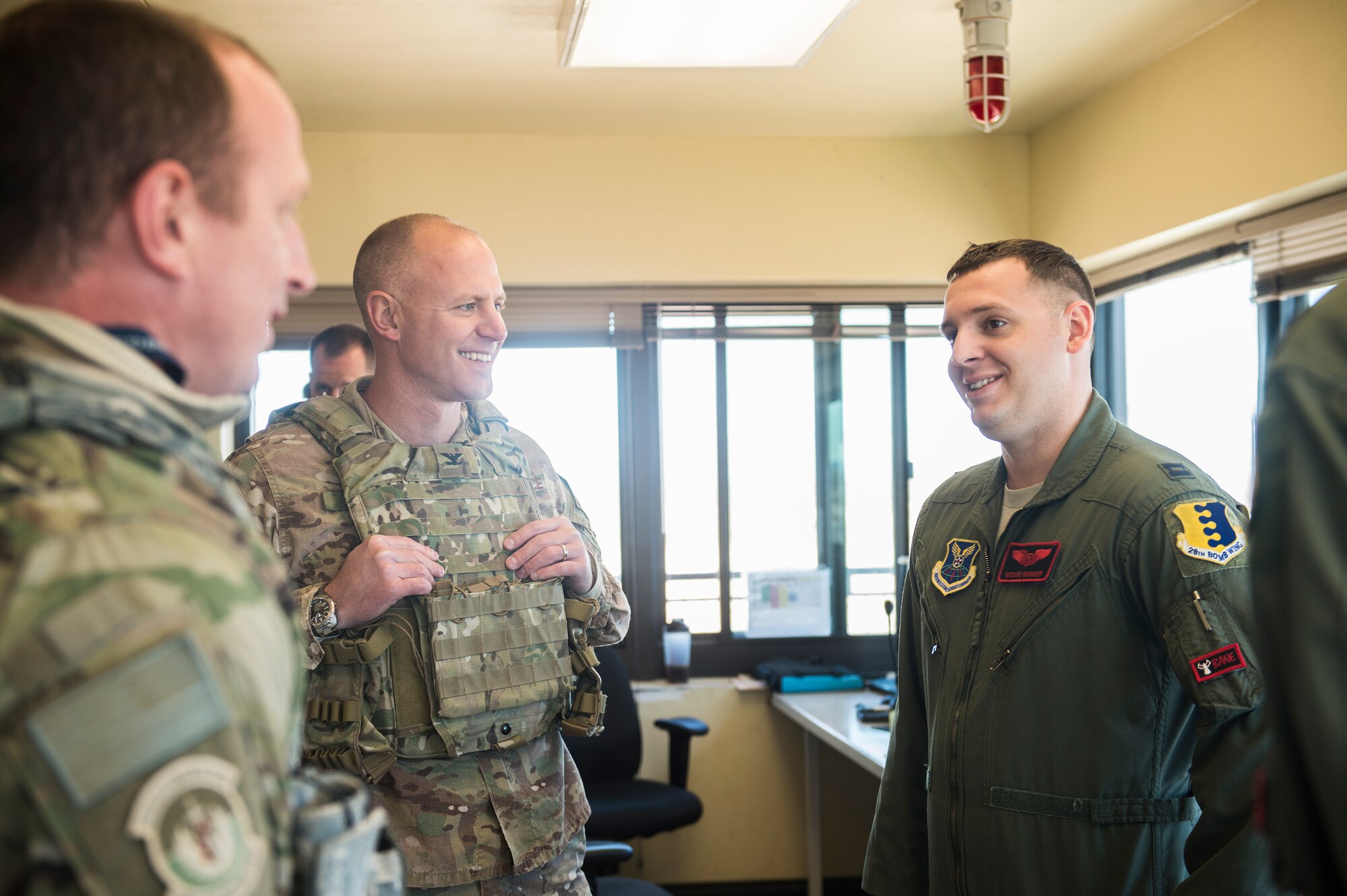 U.S. Air Force Capt. Anthony Bunker, 34th Bomb Squadron, right, shares a laugh with Col. Joseph Locke, 93rd Air Ground Operations Wing commander, middle, and Lt. Col. Steve Raspet, 7th Air Support Operations Squadron commander, left, at the Oro Grande Training Complex at Fort Bliss, Texas, Feb. 4, 2016. (U.S. Air Force photo by Senior Airman Olivia Dominique/Released)