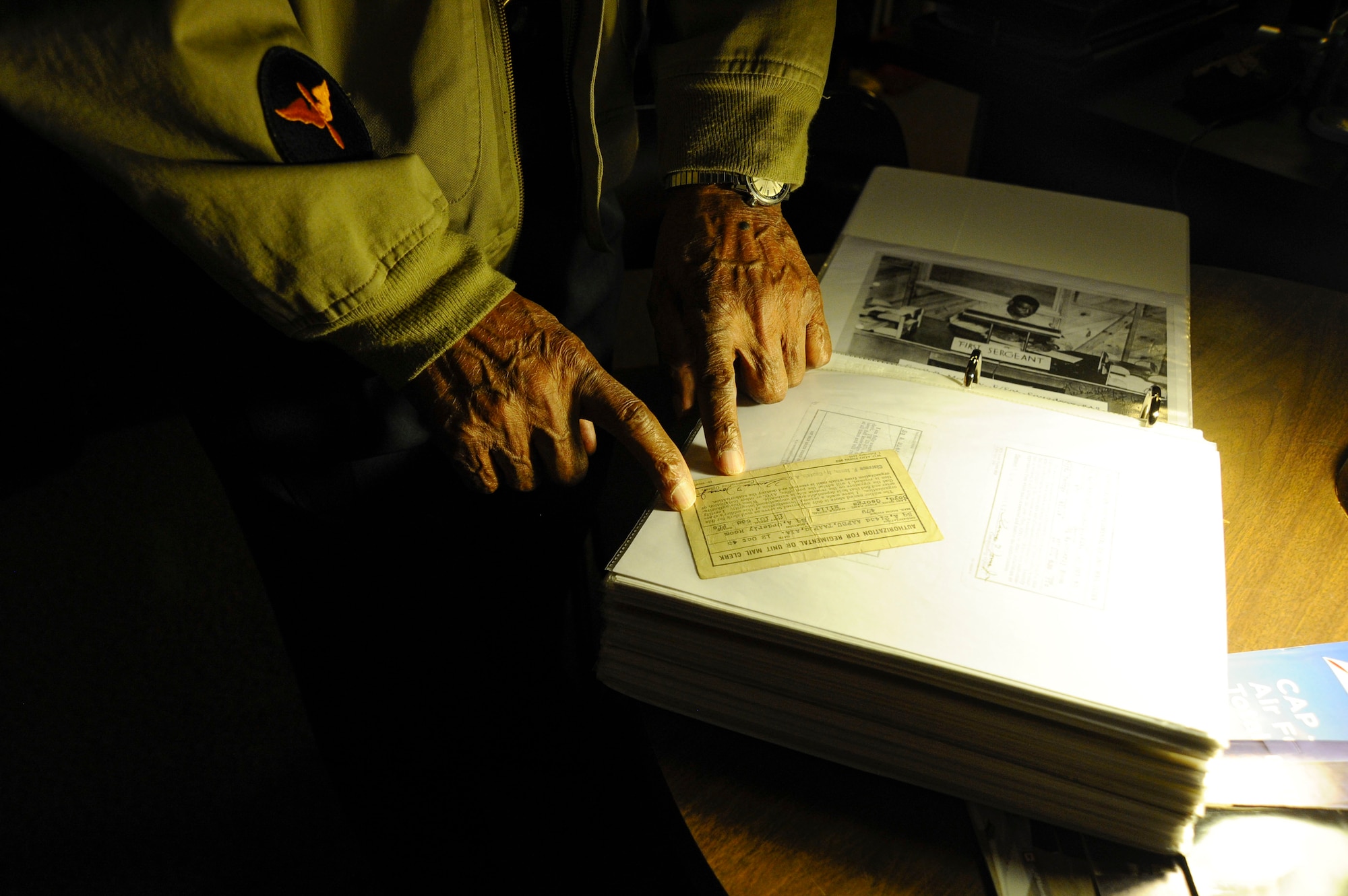 Retired Maj. George Boyd, exhibits photographs and other wartime documentation from his time in the service, Feb. 4, 2016, at his home in Wichita, Kan. Boyd served for nearly three decades on both the enlisted and commissioned side.  (U.S. Air Force photo/Airman Jenna K. Caldwell)  