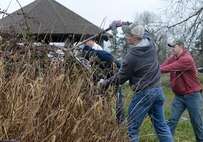 Senior Airman John Seaton and Senior Airman Austin Knight, both 627th Civil Engineer Squadron structural journeymen, remove plants from Morey Pond on Joint Base Lewis-McChord, Wash, Feb. 27, 2016. More than 20 volunteers from the 627th CES gathered to cleanup Morey Pond on McChord Field. (U.S. Air Force photo/Senior Airman Divine Cox)