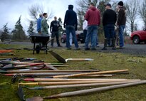 Members of the 627th Civil Engineer Squadron prepare to remove invasive plants surrounding Morey Pond on Joint Base Lewis-McChord, Wash, Feb. 27, 2016. The main purpose for the Morey Pond cleanup is to eradicate the invasive species of plants growing along the banks. (U.S. Air Force photo/Senior Airman Divine Cox)