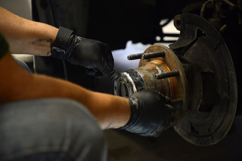 Tony Johnson, a retired Air Force C-130 crew chief, performs maintenance work on his truck at the Automotive skills Center on Joint Base Elmendorf-Richardson, Feb. 24, 2016. The ASC is a 16 bay auto shop that provides assistance with most car repairs. (U.S. Air Force photo by Airman 1st Class Javier Alvarez)