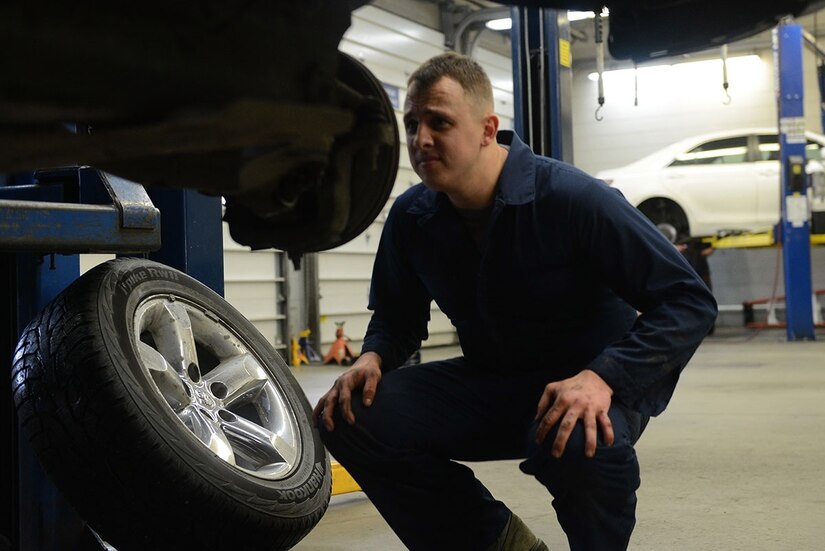 Senior Airman Brian Sanchez, a 732d Air Mobility Squadron aircraft services specialist, inspects the brakes on his truck at the Automotive Skills Center on Joint Base Elmendorf-Richardson, Feb. 24, 2016. Staff at the ASC assist customers performing repairs and maintenance on personally owned vehicles, which makes customers self-reliant. (U.S. Air Force photo by Airman 1st Class Javier Alvarez)