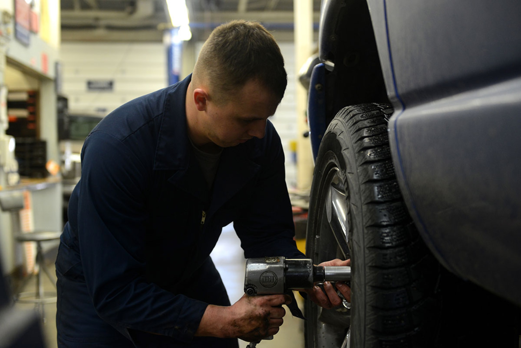 Senior Airman Brian Sanchez, a 732d Air Mobility Squadron aircraft services specialist removes a tire from his vehicle at the Automotive Skills Center on Joint Base Elmendorf-Richardson, Feb 24, 2016. The ASC is available on base to assist with more car repair and maintenance needs. (U.S. Air Force photo by Airman 1st Class Javier Alvarez)