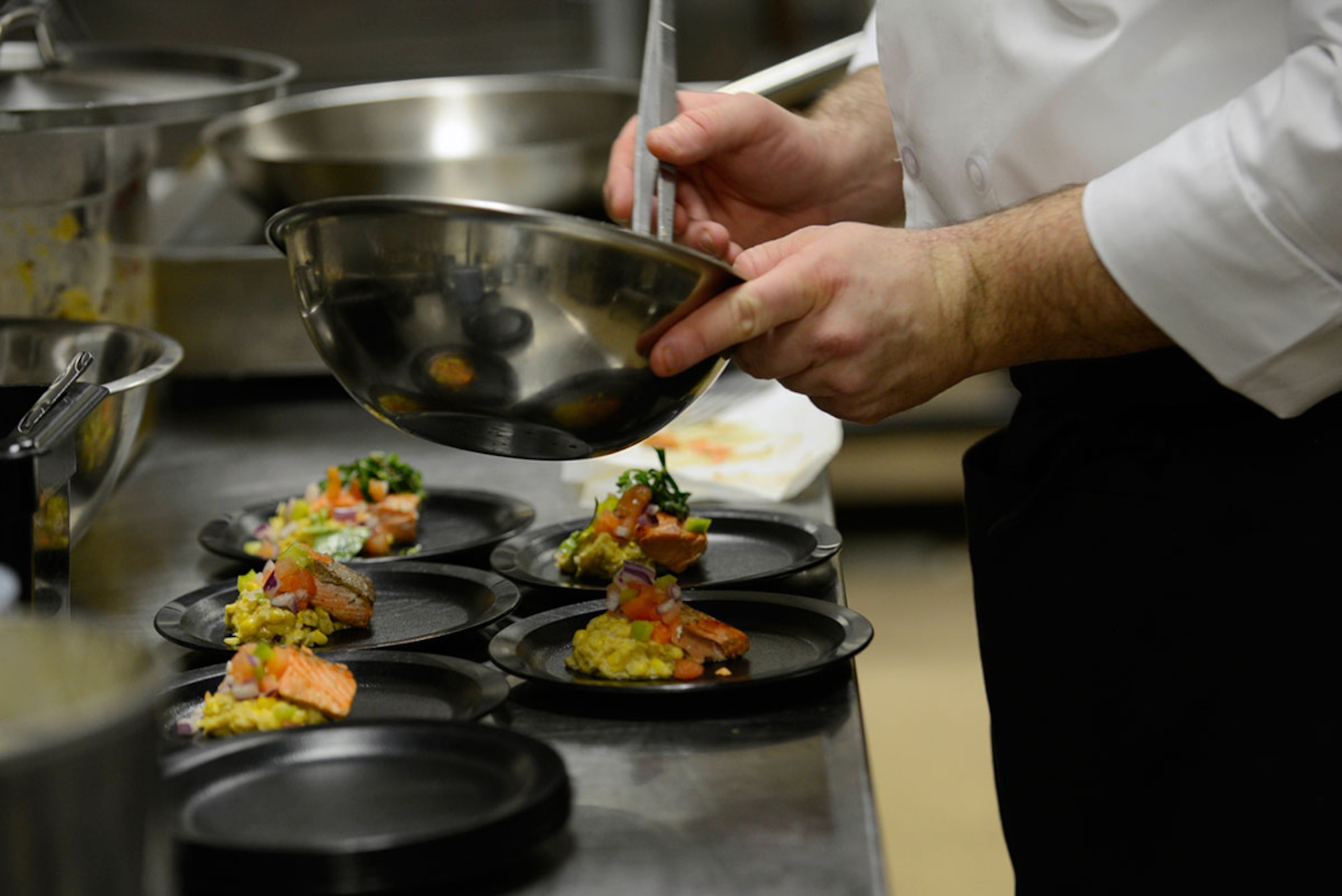 Finishing touches are added to a starter meal at the Gold Rush Inn Dining Facility at Joint Base Elmendorf-Richardson, Feb. 24, 2016.  The 10-person team of Soldiers and Airmen served up a three-course meal as part of a training event designed to prepare the team for the 41st Annual Military Culinary Arts Competitive Training Event at Fort Lee, VA. ,March 5 to 10. (U.S. Air Force photo by Airman Valerie Monroy)