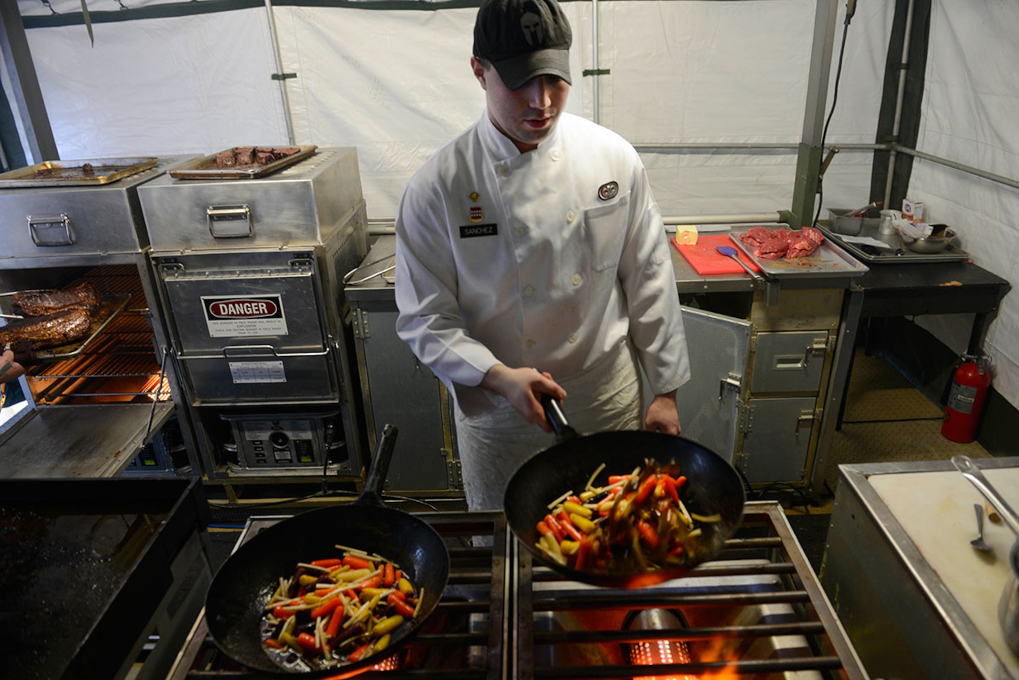 Spec. Alexander Sanchez, E Company, 6th Brigade Engineer Battalion (Airborne), ‘Team Alaska’ member, sautés vegetables in a mobile kitchen trailer at Joint Base Elmendorf-Richardson, Feb. 24, 2016.  The 10-person team of Soldiers and Airmen served up a three-course meal as part of a training event designed to prepare the team for the 41st Annual Military Culinary Arts Competitive Training Event at Fort Lee, VA., March 5 to 10. (U.S. Air Force photo by Airman Valerie Monroy)