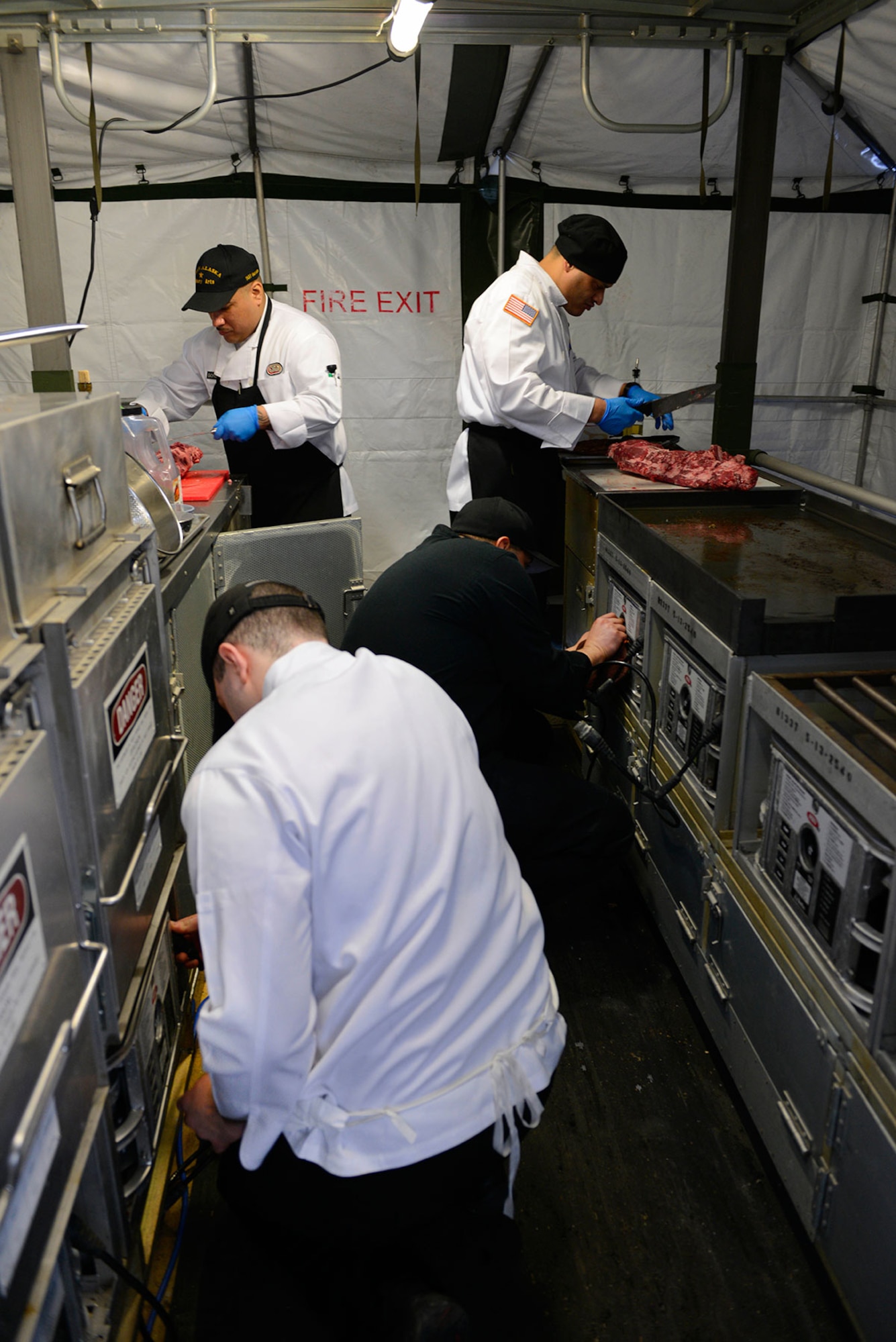 Members of ‘Team Alaska’ prepare a meal during a practice run in a mobile kitchen trailer at Joint Base Elmendorf-Richardson, Feb. 24, 2016.  The 10-person team of Soldiers and Airmen, served up a three-course meal as part of a training event designed to prepare the team for the 41st Annual Military Culinary Arts Competitive Training Event at Fort Lee, VA., March 5 to 10. (U.S. Air Force photo by Airman Valerie Monroy)