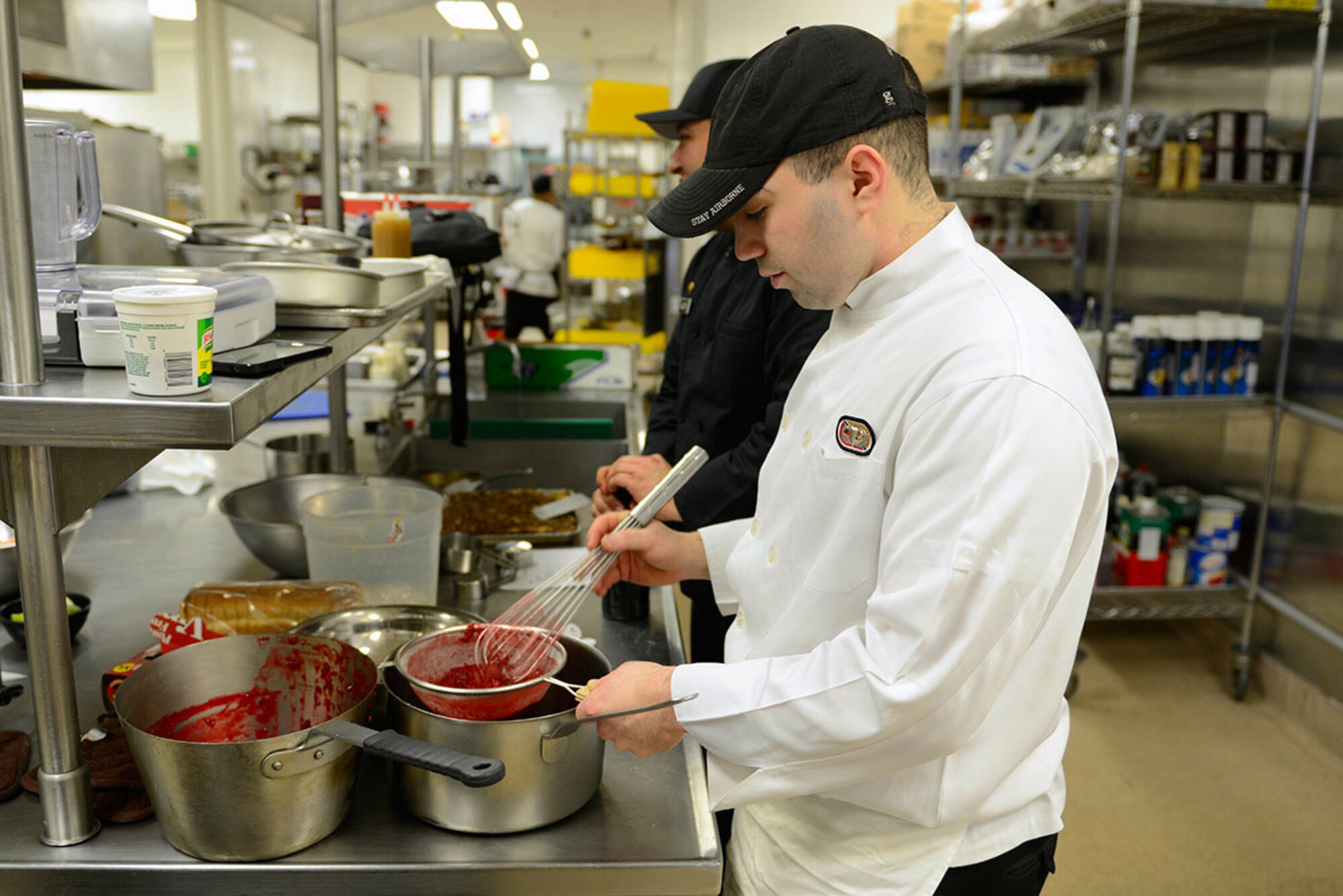 Spec. Alexander Sanchez, E Company, 6th Brigade Engineer Battalion (Airborne), ‘Team Alaska’ member, strains a sauce at the Gold Rush Inn Dining Facility at Joint Base Elmendorf-Richardson, Feb. 24, 2016.  The 10-person team of Soldiers and Airmen served up a three-course meal as part of a training event designed to prepare the team for the 41st Annual Military Culinary Arts Competitive Training Event at Fort Lee, VA., March 5 to 10. (U.S. Air Force photo by Airman Valerie Monroy)