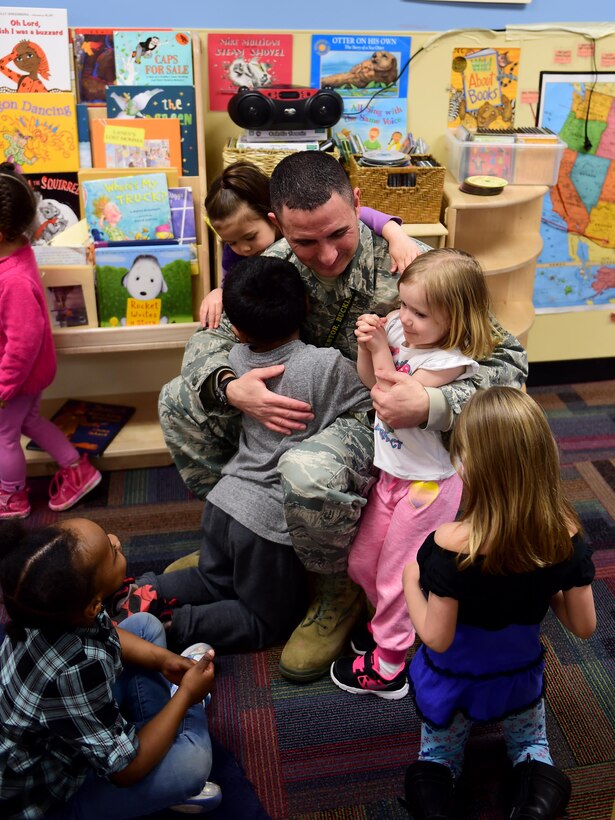 Chief Master Sgt. Brian Kruzelnick, 460th Space Wing command chief, receives hugs from children Feb. 23, 2016, at the A-Basin Child Development Center on Buckley Air Force Base, Colo. Kruzelnick talked to the children about how this was the 40th anniversary of National African American History Month and the impact black Americans have had on the U.S. (U.S. Air Force photo by Airman 1st Class Gabrielle Spradling/Released)