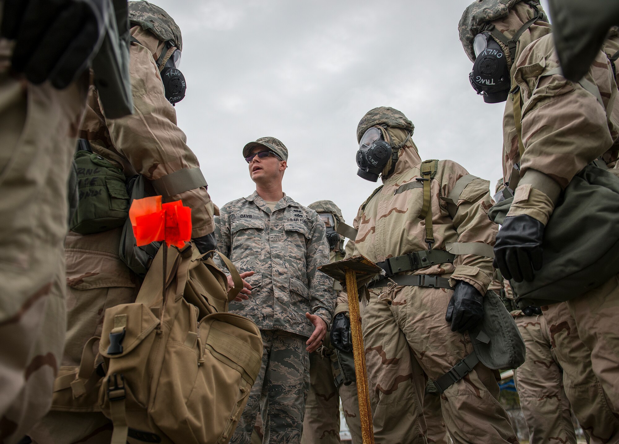 Staff Sgt. Brandon Davis, 96th Civil Engineer Group, explains how to check the M8 contamination paper during a chemical, biological, radiological, nuclear and explosive training session at Eglin Air Force Base, Fla., Feb. 23.  The course was preparatory training with instructors prior to the live CBRNE exercise.  The Airmen were taught the proper procedures during the training before performing them by themselves during the exercise.  (U.S. Air Force photo/Samuel King Jr.)