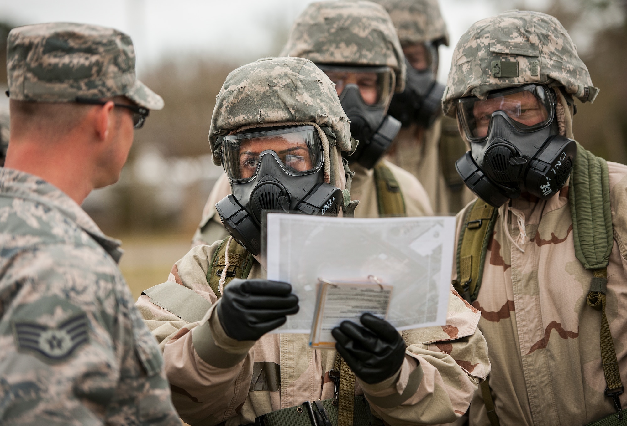 Airmen look to an instructor for help with map designations during a chemical, biological, radiological, nuclear and explosive training session at Eglin Air Force Base, Fla., Feb. 23.  The course was preparatory training with instructors prior to the live CBRNE exercise.  The Airmen were taught the proper procedures during the training before performing them by themselves during the exercise.  (U.S. Air Force photo/Samuel King Jr.)