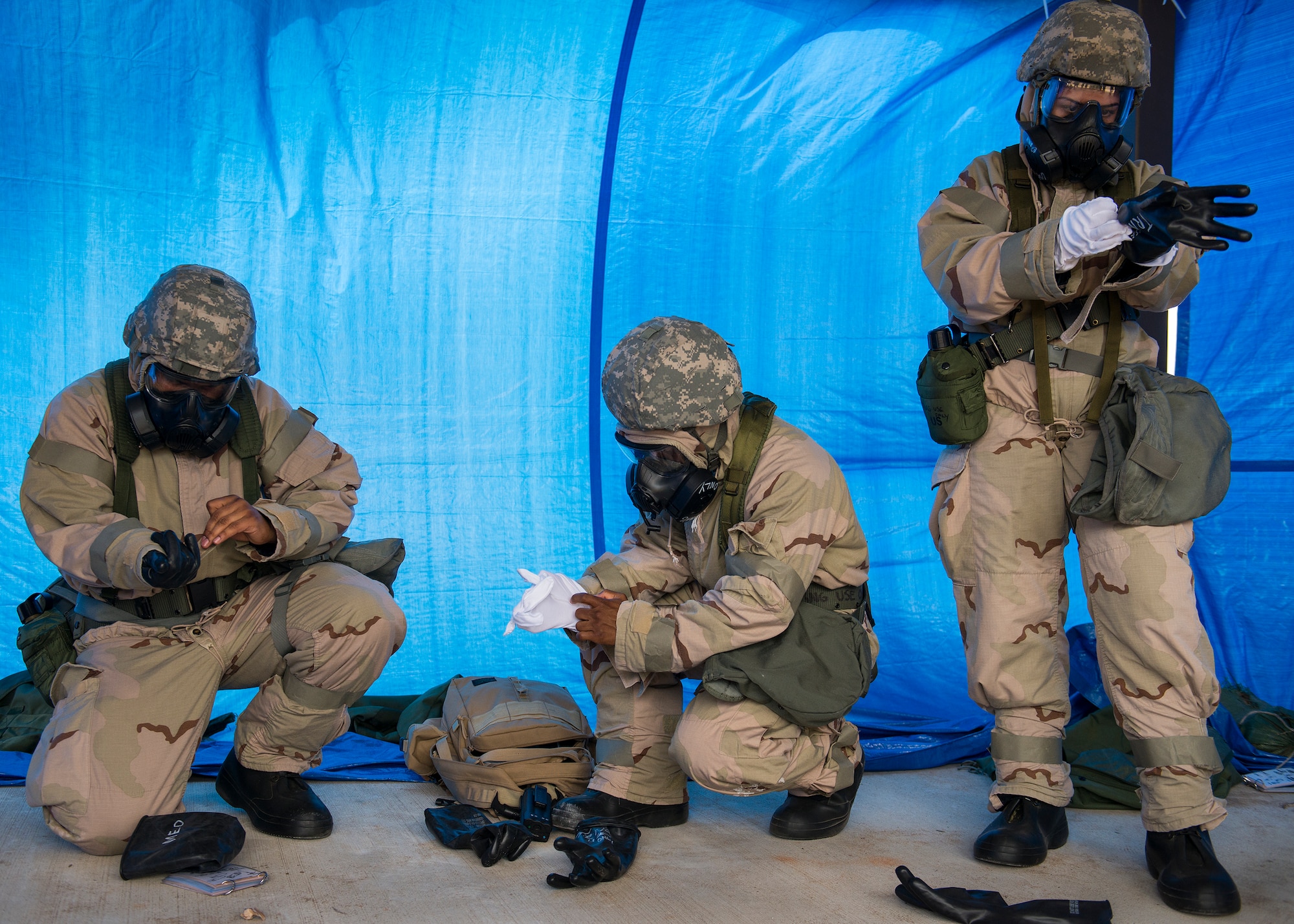 Airmen don their protective gear during a chemical, biological, radiological, nuclear and explosive exercise at Eglin Air Force Base, Fla., Feb. 23.  The exercise evaluated the Airmen’s ability to meet wartime and contingency taskings of employing and sustaining the force and the ability to survive and operate.  (U.S. Air Force photo/Samuel King Jr.)