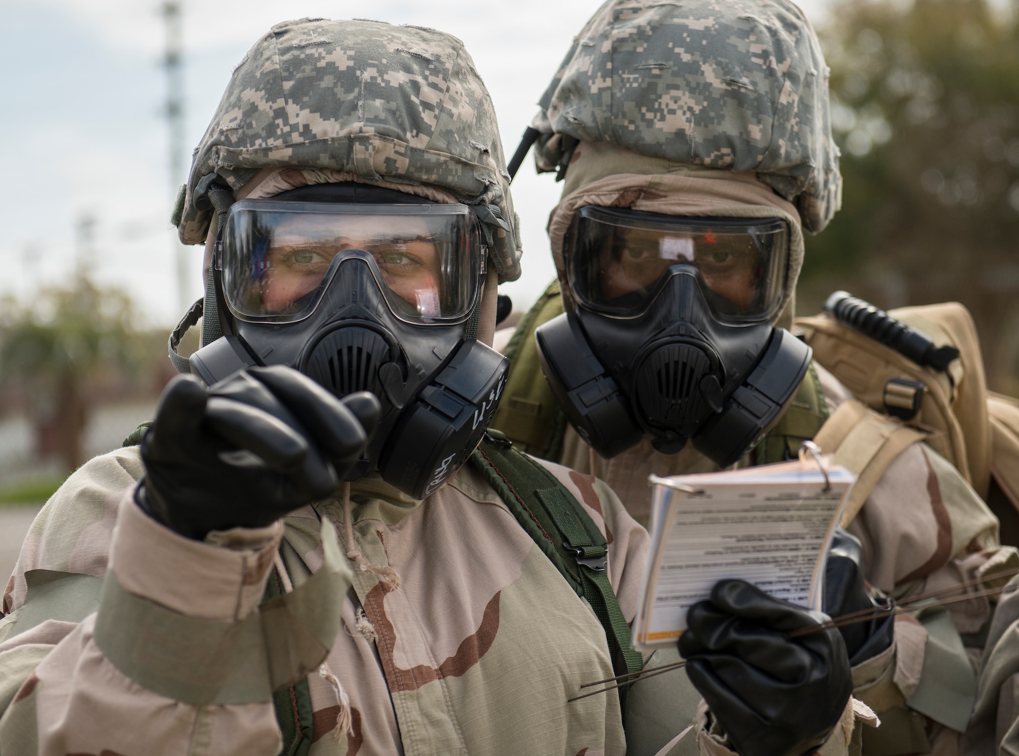An Airman points to the location of an unexploded ordnance during a chemical, biological, radiological, nuclear and explosive exercise at Eglin Air Force Base, Fla., Feb. 23.  The exercise evaluated the Airmen’s ability to meet wartime and contingency taskings of employing and sustaining the force and the ability to survive and operate.  (U.S. Air Force photo/Samuel King Jr.)