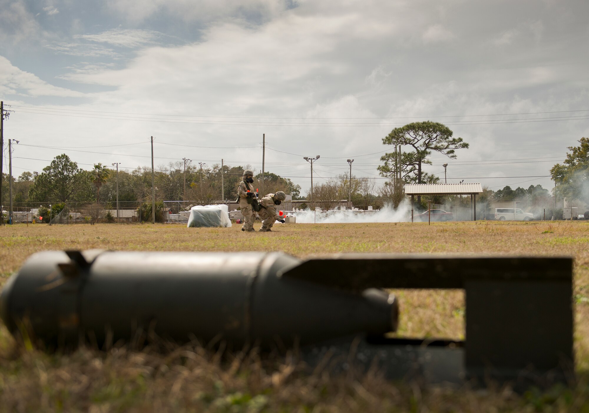 Airmen place markers at specific distances away from an unexploded ordnance during a chemical, biological, radiological, nuclear and explosive exercise at Eglin Air Force Base, Fla., Feb. 23.  The exercise evaluated the Airmen’s ability to meet wartime and contingency taskings of employing and sustaining the force and the ability to survive and operate.  (U.S. Air Force photo/Samuel King Jr.)