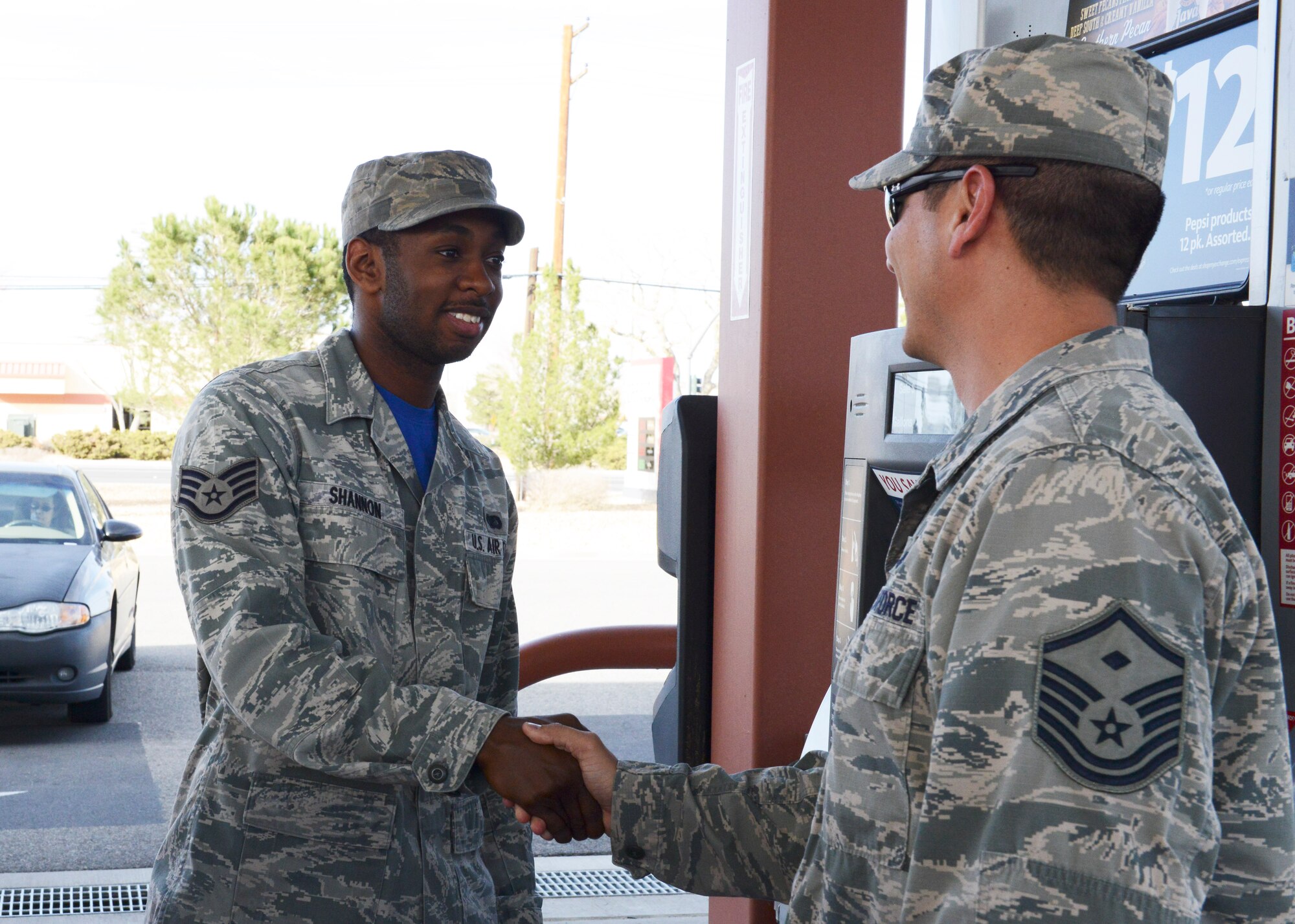 From left: Staff Sgt. Stephen Shannon, 31st Test and Evaluation Squadron, shakes hands with Master Sgt. Steven Dale, 412th Mission Support Group, after receiving a random act of kindness. The Edwards First Sergeants Council went to the Edwards Express Feb. 26 in the afternoon to pay for 20 Airmen's fill up. The event was to show appreciation for younger enlisted Airmen. (U.S. Air Force photo by Kenji Thuloweit)