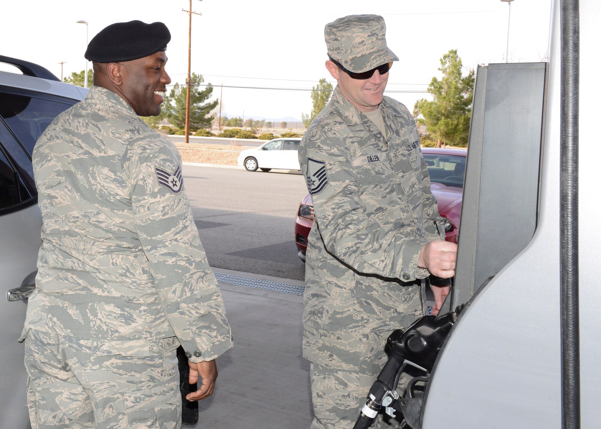 Master Sgt. Timothy Dillen, Air Force Research Laboratory, pays for Staff Sgt. Anthony Hopkins' gas at the Edwards Express gas station Feb. 26. The Edwards First Sergeants Council bought a tank of gas for about 20 Airmen E-5 and below, along with spouses married to junior Airmen. The event was titled, Random Acts of Kindness. (U.S. Air Force photo by Kenji Thuloweit)