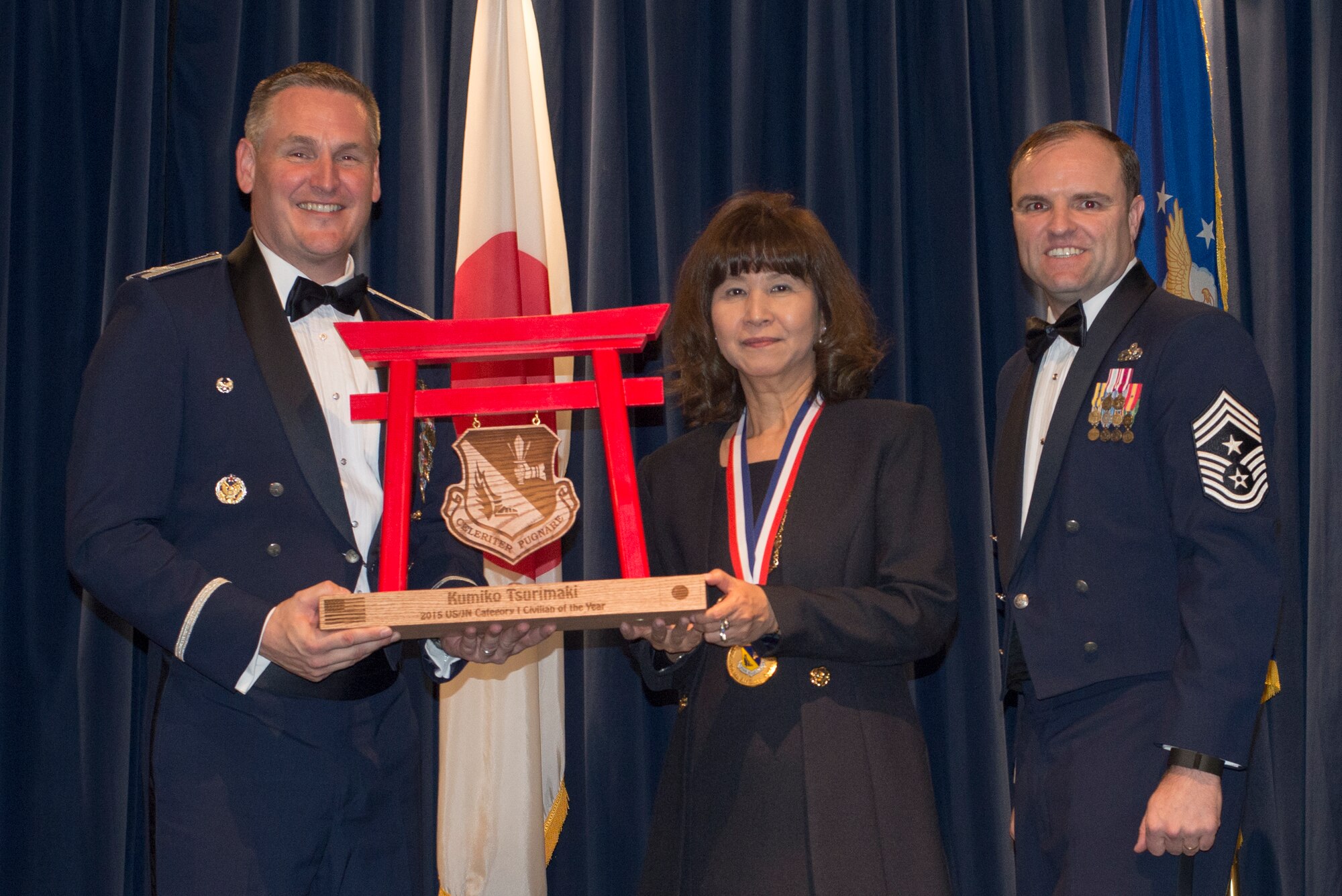 Kumiko Tsurimaki, 374th Civil Engineer Squadron, receives the 2015 US/Japan Category I Civilian of the Year Award at Yokota Air Base, Japan, Feb. 19, 2016. (U.S. Air Force photo by Senior Airman David Danford/Released)	