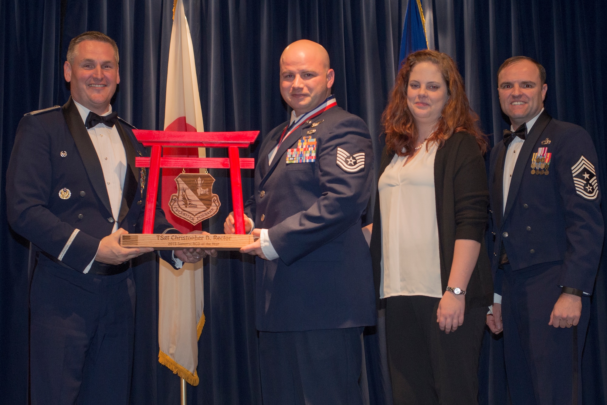 Staff Sgt. Christopher Rector, 459th Airlift Squadron, receives the 2015 Samurai NCO of the Year Award at Yokota Air Base, Japan, Feb. 19, 2016. (U.S. Air Force photo by Senior Airman David Danford/Released)