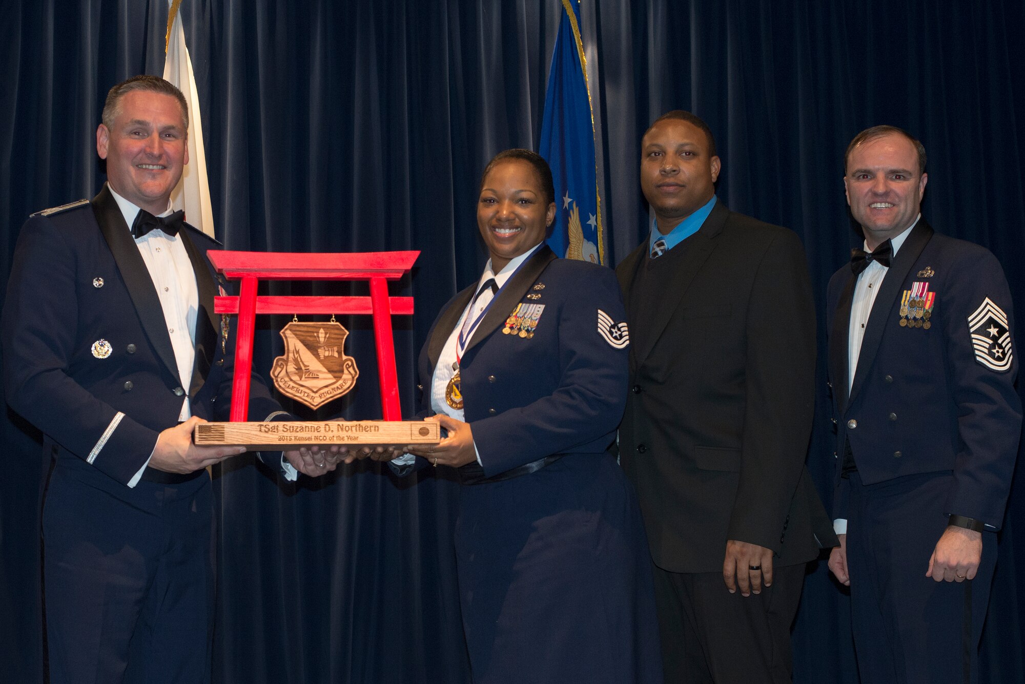 Tech. Sgt. Suzanne Northern, 5th Air Forces, receives the 2015 NCO of the Year Award for tenant units at Yokota Air Base, Japan, Feb. 19, 2016. (U.S. Air Force photo by Senior Airman David Danford/Released)