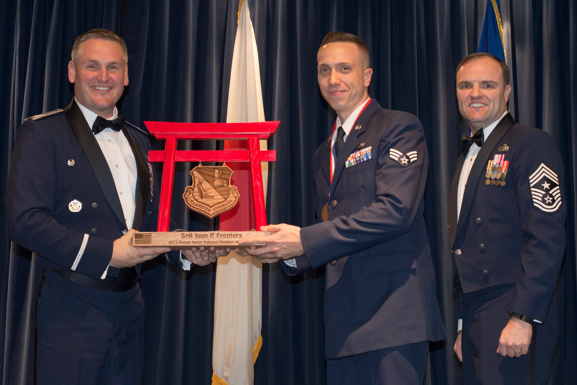 Senior Airman Juan Frontera, 730th Air Mobility Squadron, receives the 2015 Kensei Junior Enlisted Member of the Year Award at Yokota Air Base, Japan, Feb. 19, 2016. (U.S. Air Force photo by Senior Airman David Danford/Released)