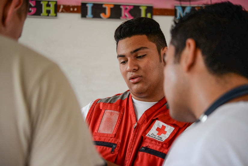 Roy Broonfield, Red Cross volunteer, helps U.S. Army pharmacy technicians by translating prescriptions during a Medical Readiness Training Exercise in the Cortes Department, Honduras, Feb. 19, 2016. Broonfield has volunteered with the Red Cross of Honduras for three years and wishes to continue volunteering into the future to help provide a link between the people of his country and the services they can use to remain healthy. (U.S. Air Force photo by Staff Sgt. Westin Warburton/Released)