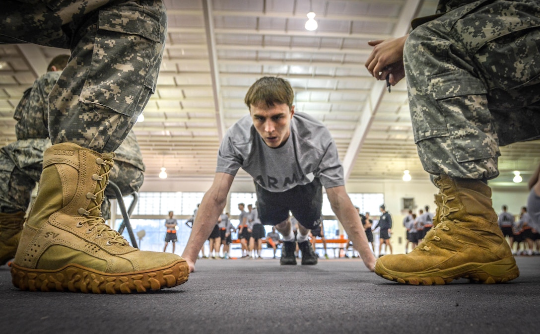 A Clemson University Reserve Officers' Training Corps cadet pumps out as many pushups as he can as two fellow cadets grade his performance during an Army Physical Fitness Test Jan. 15, 2015. U.S. Army Soldiers must pass the APFT at least once every six months. It consists of two minutes of pushups, two minutes of situps and a timed two-mile run. (U.S. Army photo by Sgt. Ken Scar)