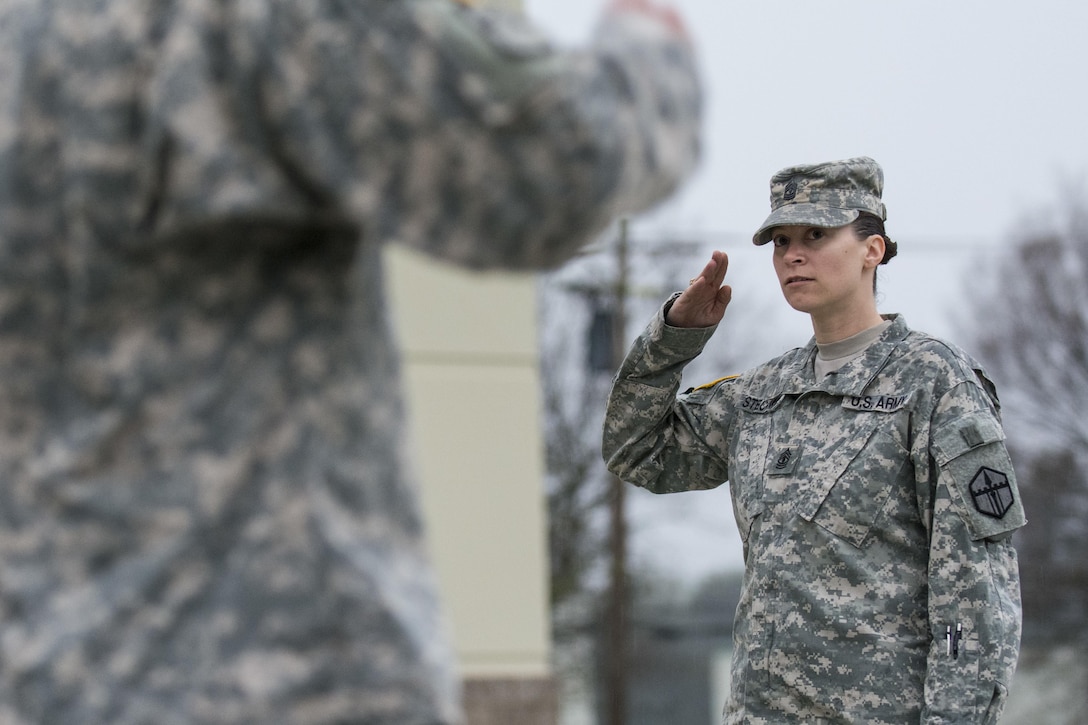 First Sgt. Raquel Steckman salutes her platoon sergeants with the 374th Engineer Company (Sapper), headquartered in Concord, Calif., during formation. Steckman is the first female in the Army appointed to a combat engineer unit as a first sergeant. (U.S. Army photo by Sgt. 1st Class Michel Sauret)