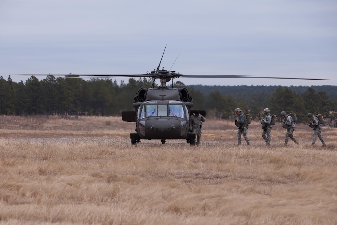 U.S. Army Soldiers of the United States Army Special Operations Command (USASOC) conduct a parachute jump using MC-6 parachutes and a UH-60 Black Hawk helicopter at Saint Mere Eglise Drop Zone on Fort Bragg, N.C., Feb. 21, 2015.  USASOC conducts airborne operations to keep its Soldiers at a high level of combat readiness. (U.S. Army photo by Spc. Chenyang Liu/Released)