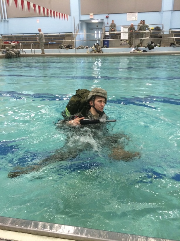 U.S. Army Reserve Staff Sgt. Robby Courson, a Soldier with the Headquarters Headquarters Company, navigates through the pool for water survival during the 301st Maneuver Enhancement Brigade's Best Warrior Competition, which ran Feb. 22-27, 2015, at Joint Base Lewis-McChord, Wash. Courson went on to win the NCO category. (U.S. Army photo by Sgt. 1st Class Shaun Spencer/Released)