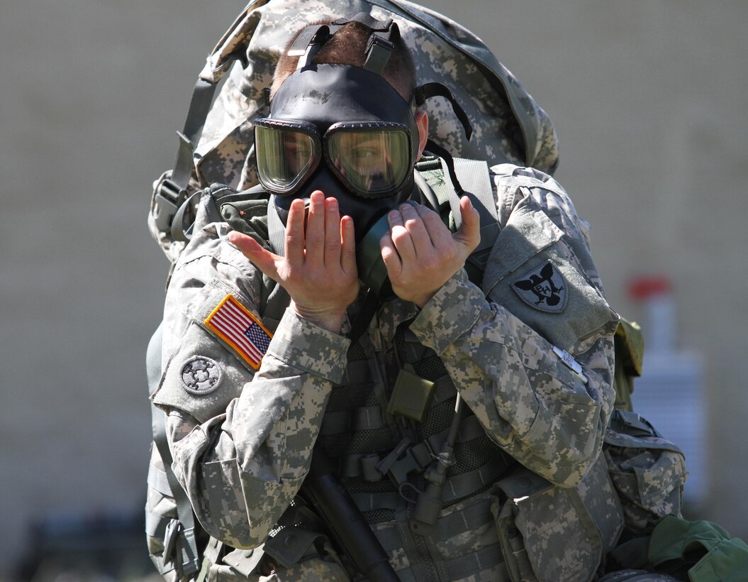Army Reserve Sgt. Vincent C. Schimke, 86th Training Division, Fort McCoy, Wis., dons and clears his protective mask during the React to Chemical or Biological Hazard Attack event of the of the 84th Training Command/11th Aviation Command/Army Reserve Careers Division Combined Command Best Warrior Competition on Fort Knox, Ky., March 30, 2015. (U.S. Army Photo by Sgt. 1st Class Clinton Wood, 84th Training Command Public Affairs)