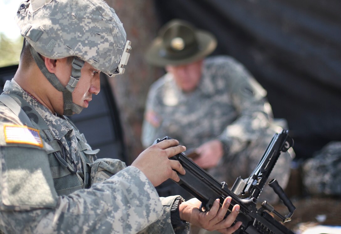 Spc. Jason Pangelinan, a health care specialist, representing the 9th Mission Support, is tested on assembling three different weapons during the "box of weapons" mystery event during the 2015 U.S. Army Reserve Best Warrior Competition at Fort Bragg, N.C., May 5. This year's Best Warrior competition will determine the top noncommissioned officer and junior enlisted Soldier who will represent the Army Reserve in the Department of the Army Best Warrior competition later this year at Fort Lee, Va. (U.S. Army photo by Staff Sgt. Sharilyn Wells/Released)