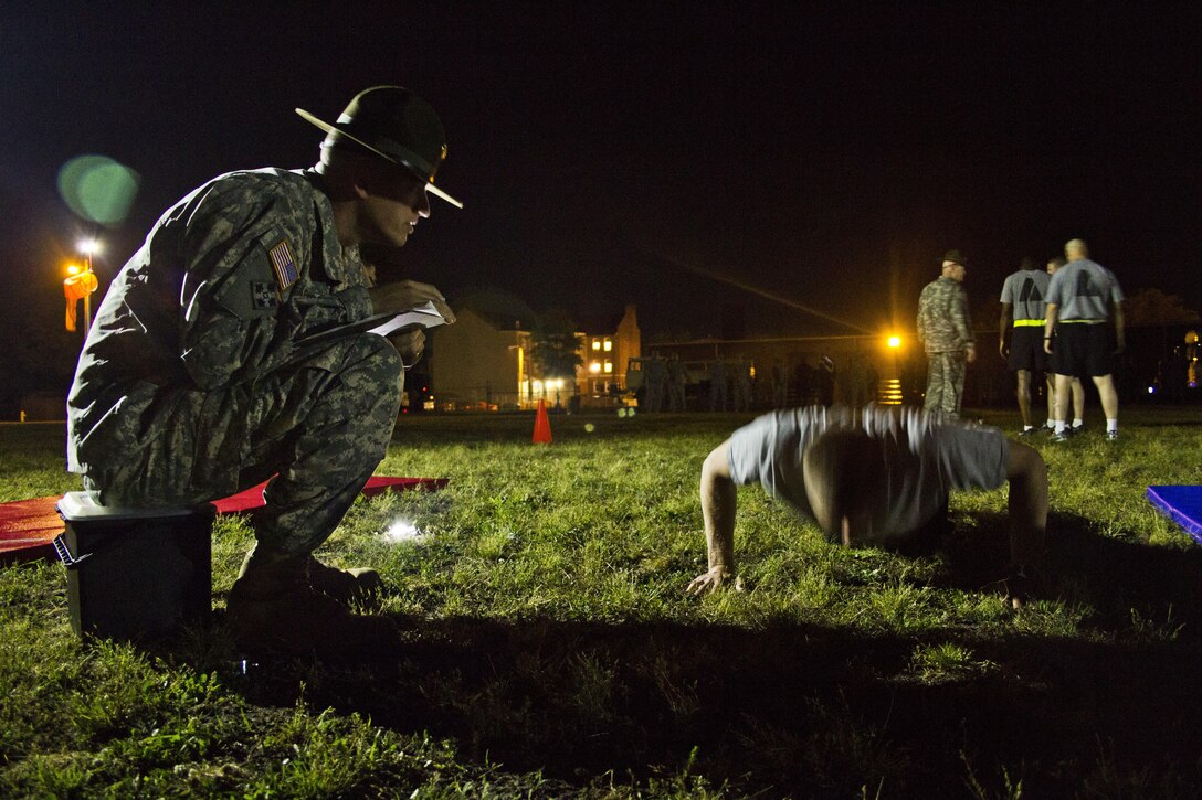 Drill Sergeant Sgt. 1st Class Adam Derrick, 2nd of the 397th, ensures proper pushup form during the 2015 U.S. Army Reserve Best Warrior Competition at Fort Bragg, N.C., May 5. This year's Best Warrior competition will determine the top noncommissioned officer and junior enlisted Soldier who will represent the Army Reserve in the Department of the Army Best Warrior competition later this year at Fort Lee, Va. (U.S. Army photo by Sgt. Felix R. Fimbres/Released)