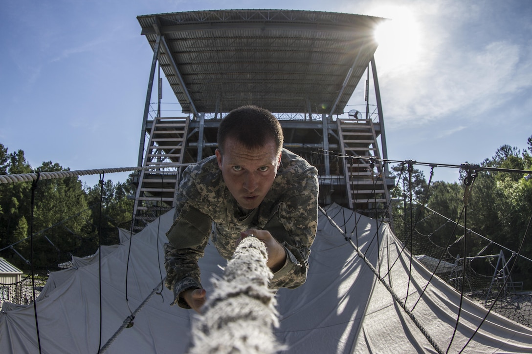 Chaplain candidates in the Basic Officer Leaders Course tackle Victory Tower under the watchful eye of the Soldiers of the 104th Training Division (LT). (U.S. Army photo by Sgt. 1st Class Brian Hamilton)