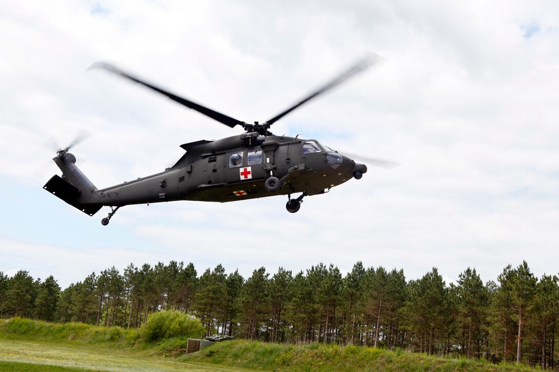U.S. Army Reserve Soldiers with Company F, 1st Battalion, 214th Aviation Regiment, Johnstown, Pa., land a UH-60 Black Hawk helicopter in a simulated emergency evacuation exercise during Global Medic at Fort McCoy, Wis., June 14, 2015. Global Medic is the premier medical field training event in the Department of Defense and is the only joint accredited exercise conceived, planned and executed by Army Reserve Soldiers. Service members from multiple DoD branches train together in a joint force environment, further strengthening their abilities to serve together around the globe. (U.S. Army photo by Pfc. Christopher Martin/Released)