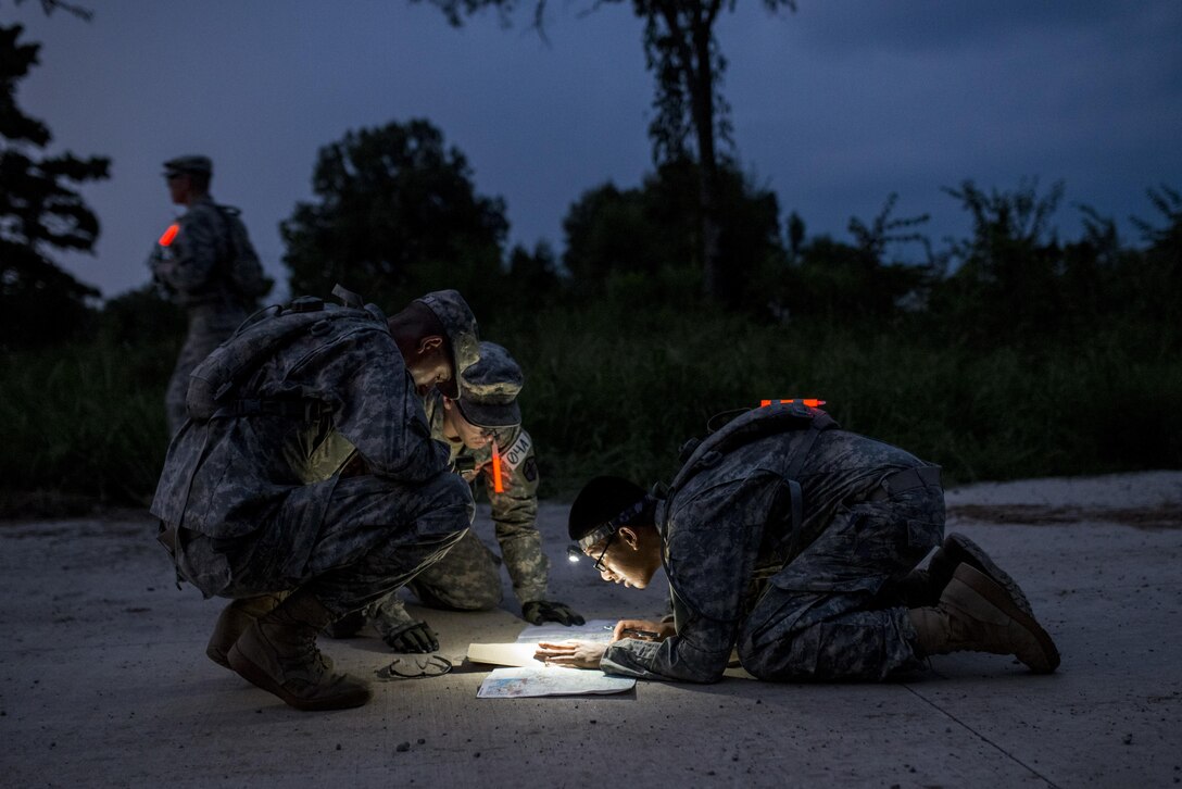 U.S. Army Reserve combat engineers from the 374th Engineer Company (Sapper), of Concord, Calif., plot points on a map as the night sets in during a team-based land navigation course as part of the 2015 Sapper Stakes competition at Fort Chaffee, Ark., Aug. 30. The competition is designed to build teamwork, enhance combat engineering skills and promote leadership among the units. (U.S. Army photo by Master Sgt. Michel Sauret)