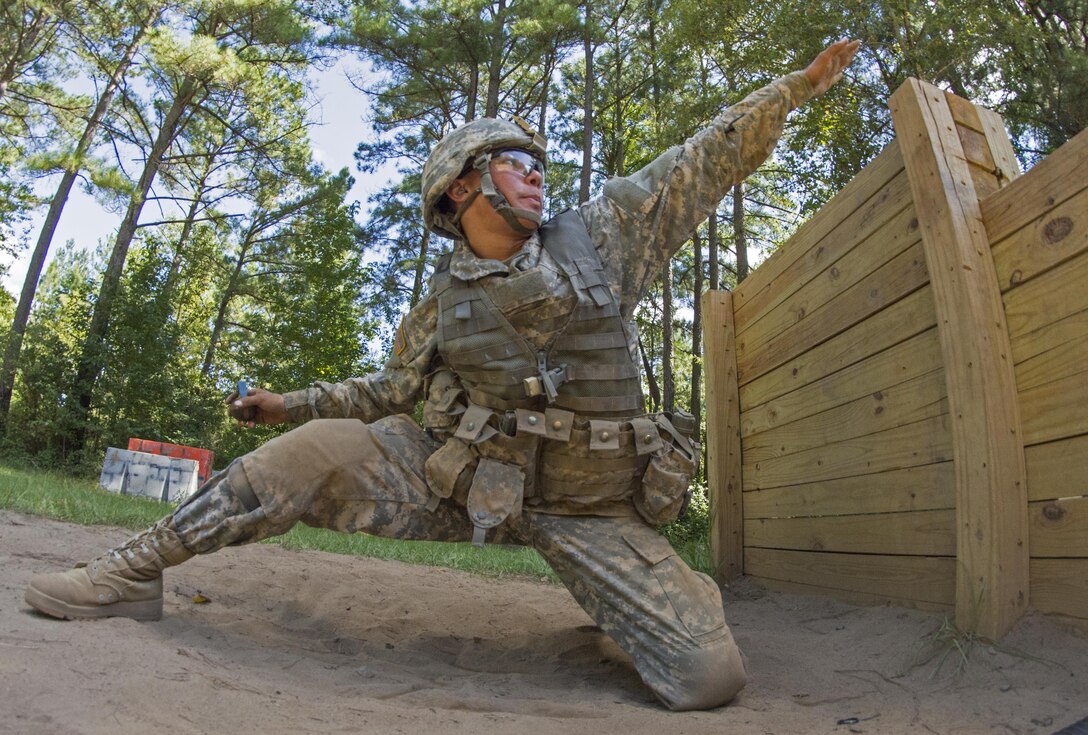 U.S. Army Pvt. Joshua Finau, of American Samoa, aims before throwing a hand grenade at the end of the live fire buddy lane during his seventh week of basic training at Fort Jackson, S.C., Sept. 19, 2015. (U.S. Army photo by Sgt. Ken Scar)