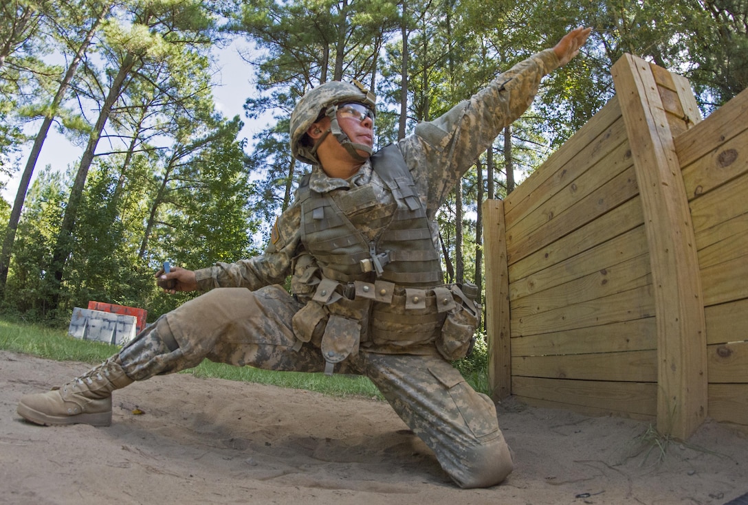 U.S. Army Pvt. Joshua Finau, of American Samoa, aims before throwing a hand grenade at the end of the live fire buddy lane during his seventh week of basic training at Fort Jackson, S.C., Sept. 19, 2015. (U.S. Army photo by Sgt. Ken Scar)