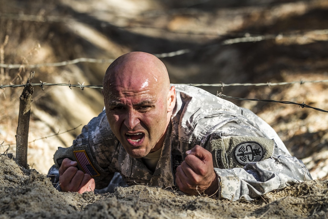 1st Sgt. Ricardo Gutierrez, MEDDAC, low crawls under the wire obstacle on the confidence course during the assessment phase of the Best Ranger competition held at Fort Jackson, S.C., Nov. 24, 2015. Gutierrez is one of three Soldiers from Fort Jackson fighting for a position on a two-Soldier team that will represent the post during the 33rd annual competition taking place at Fort Benning, Ga., in April of next year. (U.S. Army photo by Sgt. 1st Class Brian Hamilton)