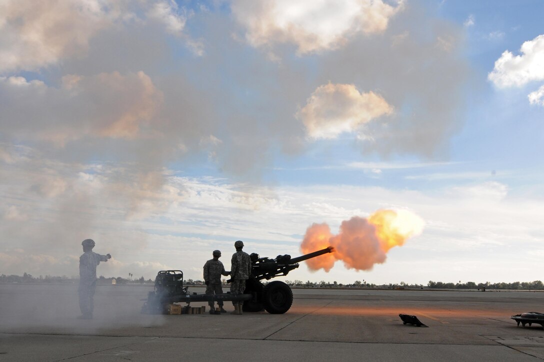 Members of Bravo Battery, 1-143rd Field Artillery, conduct a 21-gun salute during a ceremony where Maj. Gen. Mark Palzer took command of the 79th Sustainment Support Command from Maj. Gen. Megan P. Tatu at Joint Forces Training Base Los Alamitos, Calif., Dec. 5, 2015. (U.S. Army photo by Spc. Heather Doppke/released)