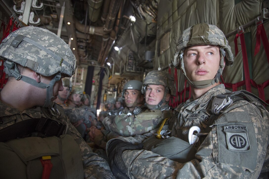 A U.S. Army paratroopers sit inside a C-130 Hercules during airborne operations in support of Operation Toy Drop, Fort Bragg, N.C., Dec. 5, 2015. Operation Toy Drop combines U.S. Army Reserve personnel, Army paratroopers, dozens of volunteers and partner nation military personnel, more than a dozen Air Force aircraft and toys, all for what has become the world’s largest combined airborne operation. (U.S. Army photo by Spc. Tracy McKithern/Released)