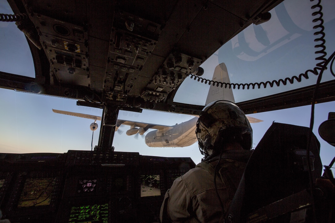 A U.S. Marine Corps MV-22 Osprey performs an air-to-air refuel from a KC-130J Hercules during a tactical exercise to recover aircraft and personnel at an undisclosed location in Southwest Asia, Dec. 28, 2015. The Osprey is assigned to Marine Medium Tiltrotor Squadron 268, Special Purpose Marine Air-Ground Task Force-Crisis Response Central Command. The Hercules is assigned to Marine Aerial Refueler Transport Squadron 352. U.S. Marine Corps photo by Lance Cpl. Clarence Leake