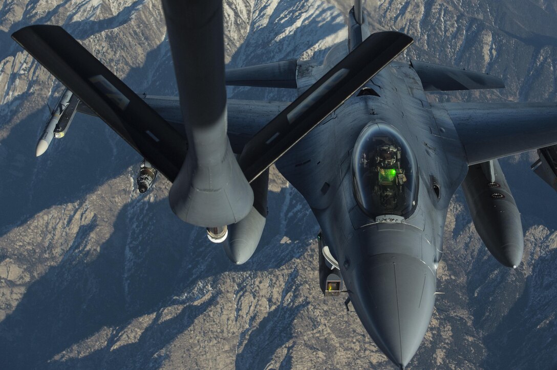 A U.S. Air Force KC-135 Stratotanker refuels a U.S. Air Force F-16 Fighting Falcon as part of the Resolute Support mission over Afghanistan, Dec. 29, 2015. U.S. Air Force photo by Staff Sgt. Corey Hook