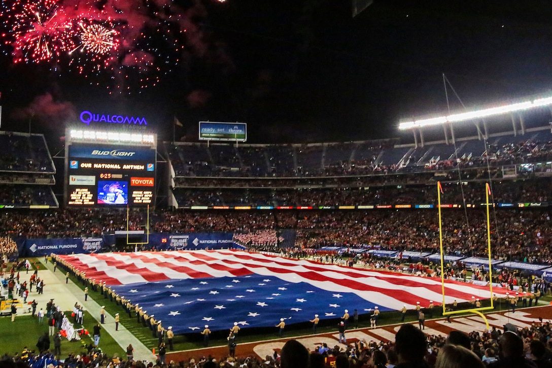 Marines unfurl the Holiday Bowl Big Flag during the bowl's pregame show in San Diego, Dec. 30, 2015. It takes a minimum of 250 people to present the 850-pound flag, which spans 100 yards by 50 yards and covers the entire field. The Marines are assigned to the 1st Marine Expeditionary Force on Marine Corps Base Camp Pendleton and Marine Corps Air Station Miramar. The University of Wisconsin Badgers beat the University of Southern California Trojans with a score of 23-21. U.S. Marine Corps photo by Lance Cpl. Caitlin Bevel