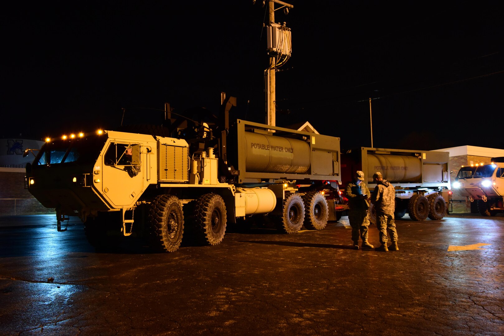 Missouri National Guardsmen stage potable water tankers at High Ridge Elementary School on Dec. 31, 2015.