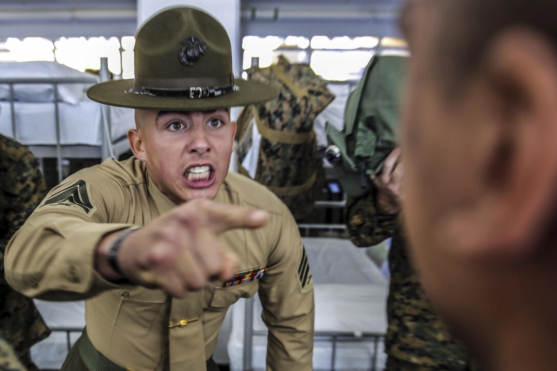 Marine Corps Sgt. Preston T. Brown instructs a recruit to respond louder at Marine Corps Recruit Depot in San Diego, Dec. 18, 2015. Annually, the depot trains more than 17,000 males recruited from the western recruiting region. U.S. Marine Corps photo by Sgt. Tyler Viglione