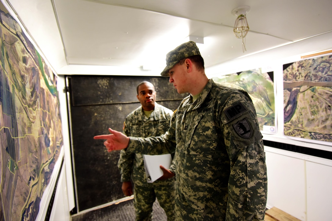 Army Capt. Scott McCollum, right, discusses a plan with Army 1st Lt. Markland Anderson before a morning to brief members of the emergency management team and local law enforcement officers in Perryville, Mo., Jan. 1, 2016. McCollum and Anderson are military police officers assigned to the Missouri National Guard’s 1137th Military Police Company. Missouri National Guard photo